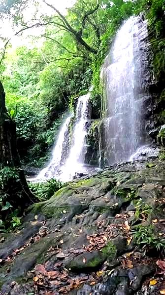 A natural waterfall surrounded by tropical vegetation near Melgar, Tolima
